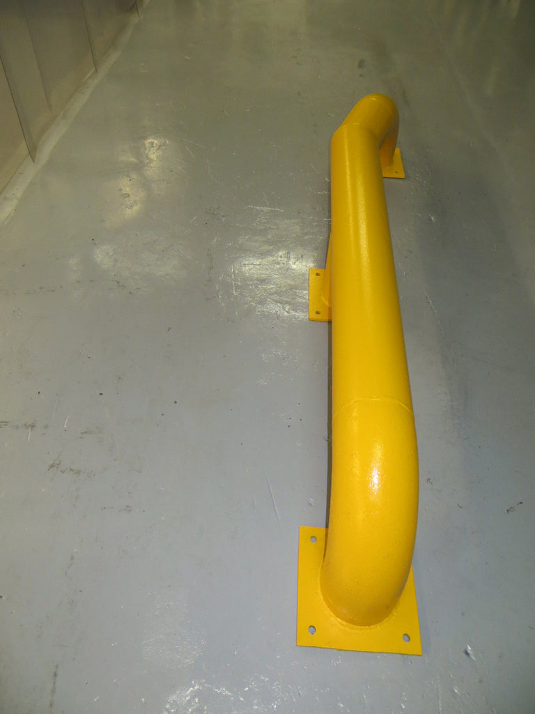 Pair of yellow loading bay wheel guides with splayed ends